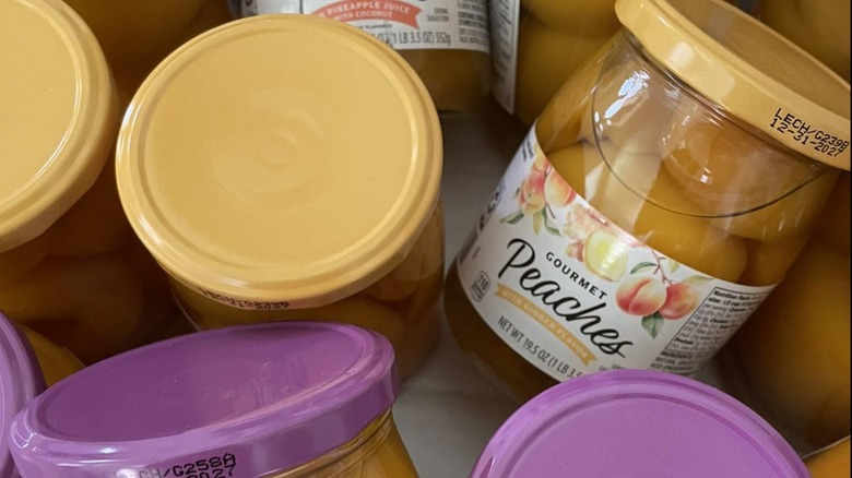 A close-up of jars of Aldi Gourmet Jarred Peaches