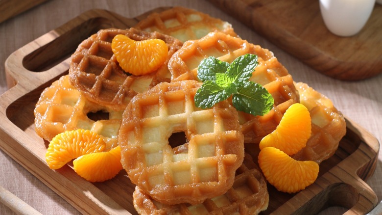 Donuts grilled in waffle iron on a cutting board