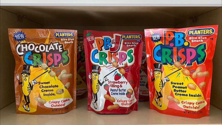 Three bags of Planters P.B. Crisps in different flavors on pantry shelf