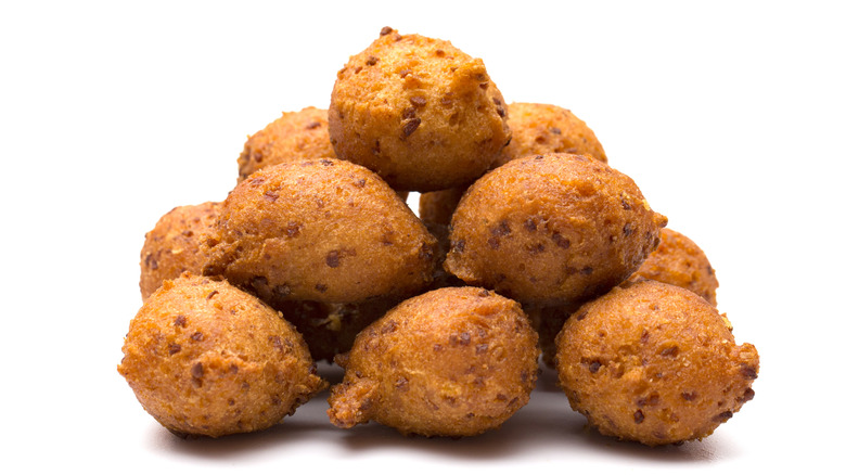 A pile of hush puppies isolated on a white background