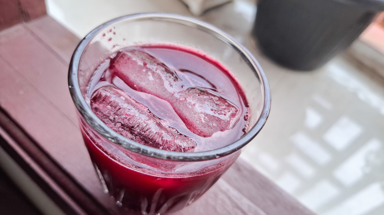 Fresh beet juice in a glass with ice