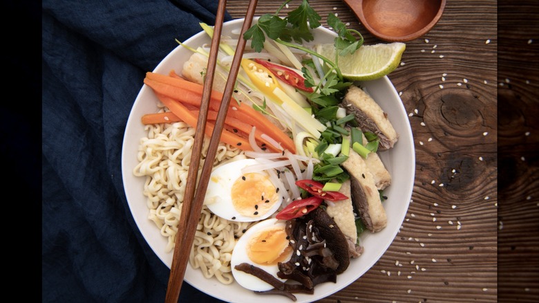 Bowl of traditional ramen with lots of vegetables