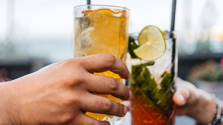 Couple toasting with two glasses of iced tea