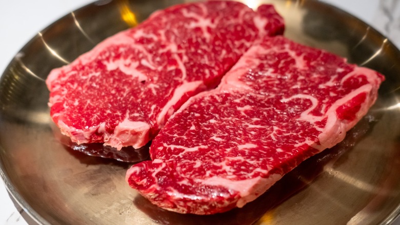 Raw Sirloin Hanwoo Beef, marbled Korean Style Meat prepared on the plate