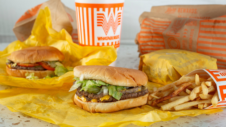 Whataburger burgers and fries on yellow wrappers