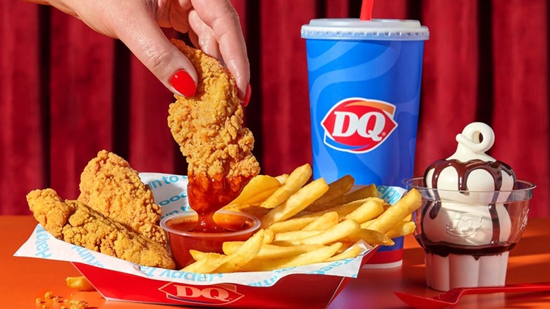 Dairy Queen's $7 Meal Deal portrayed with a woman dipping chicken tenders in sauce with fries, a drink, and ice cream nearby.