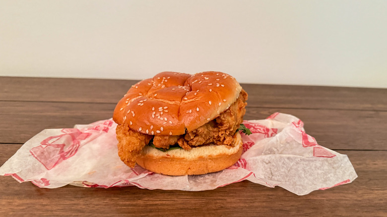 Raising Cane's fried chicken sandwich on a takeout wrapper