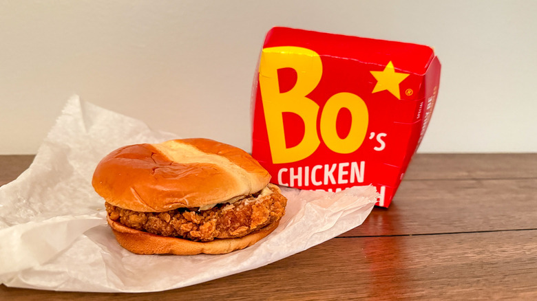 Bojangles chicken sandwich next to red fast-food takeout box