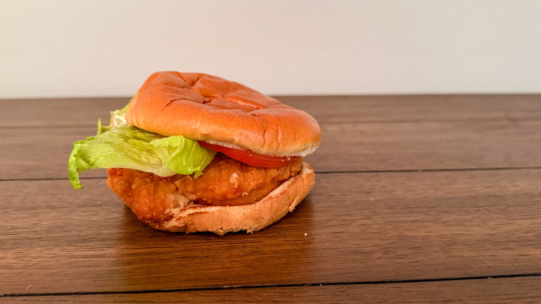 Wendy's fried chicken sandwich on a wooden table