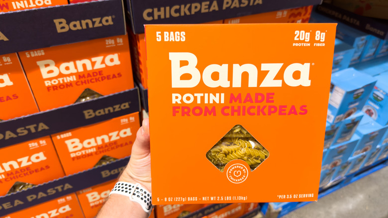 Hand holding box of Banza pasta in store