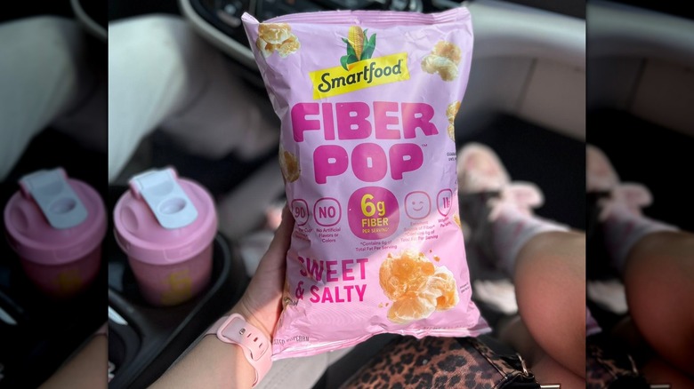 Hand holding bag of Fiber Pop in car