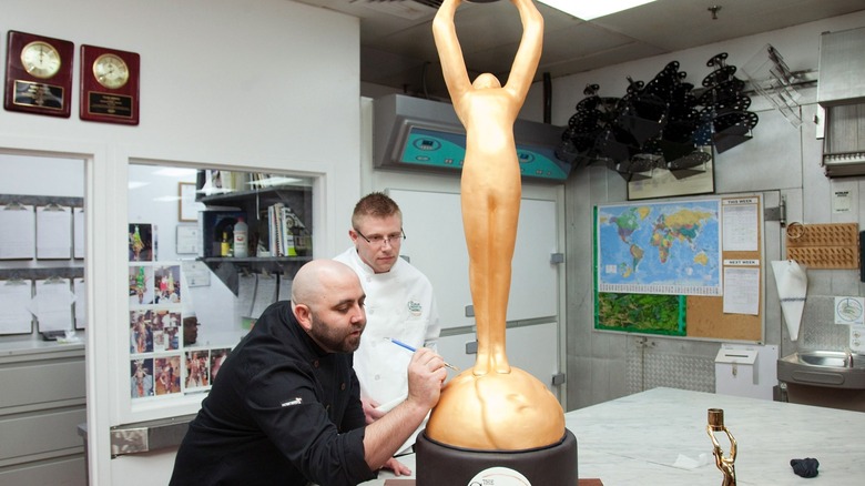 Chef Duff Goldman making a custom cake that looks like a golden human statue