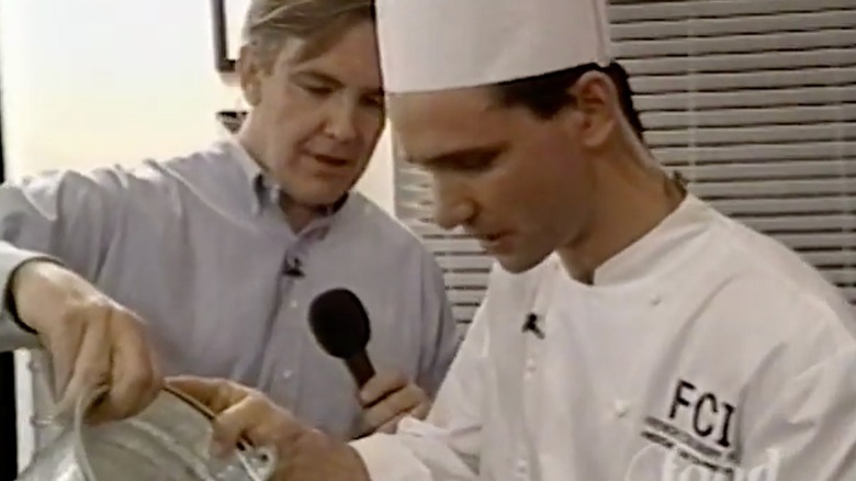 Host Gordon Elliot and a chef on the set of "Door Knock Dinners" preparing a recipe