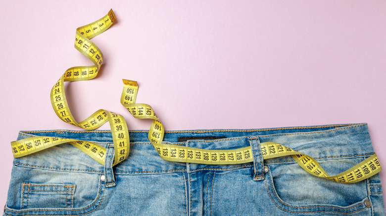 Jeans with measuring tape around waistline