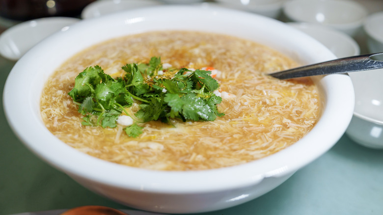 Bowl of shark fin soup with parsley on top