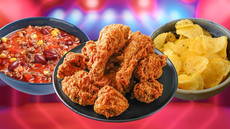 Bowl of Chili, plate of fried chicken, bowl of plain regular potato chips