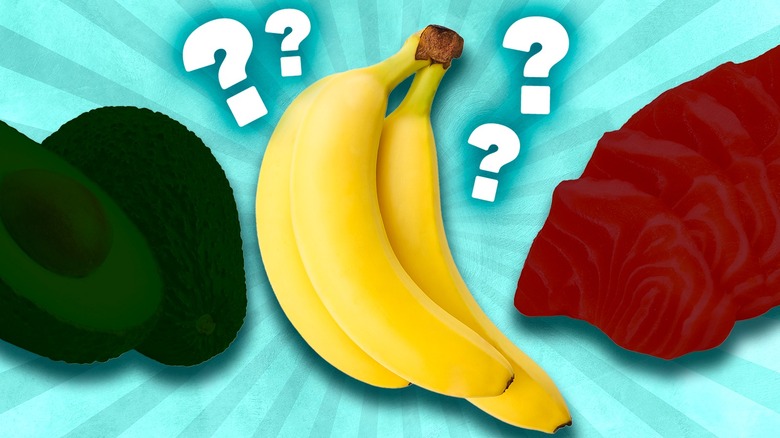 Avocados, bananas, and salmon with question marks on blue background