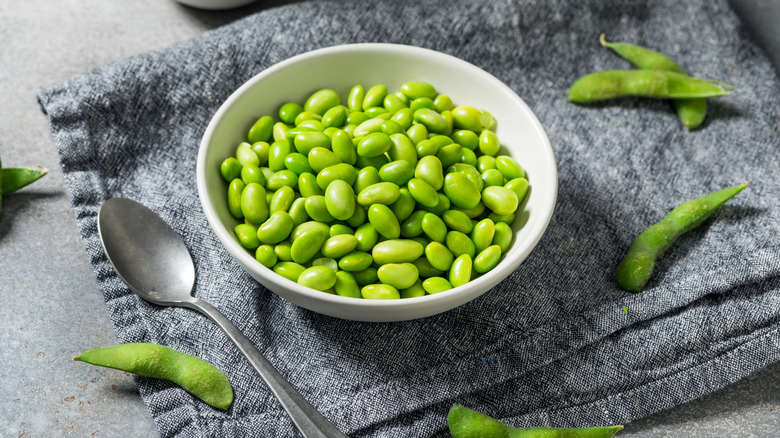 A bowl of edamame on a towel
