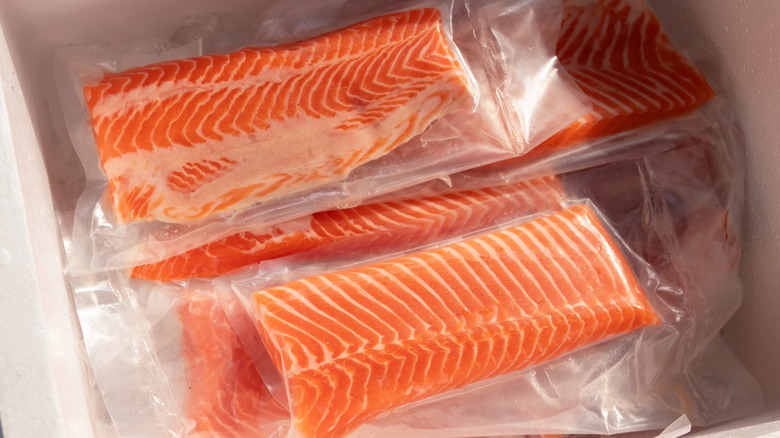 Frozen salmon fillets in freezer drawer