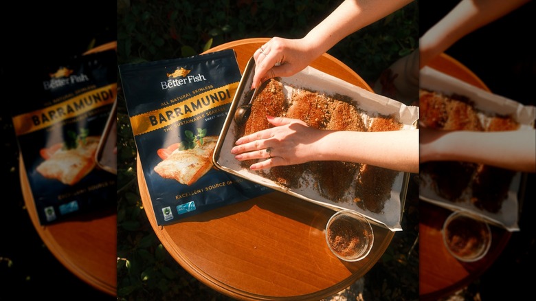 Hands pressing fish fillets into pan with seasoning, with Better Fish bag in background