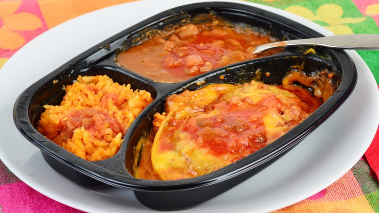 Mexican TV Dinner cooked in plastic dish and served on white plate against colorful background