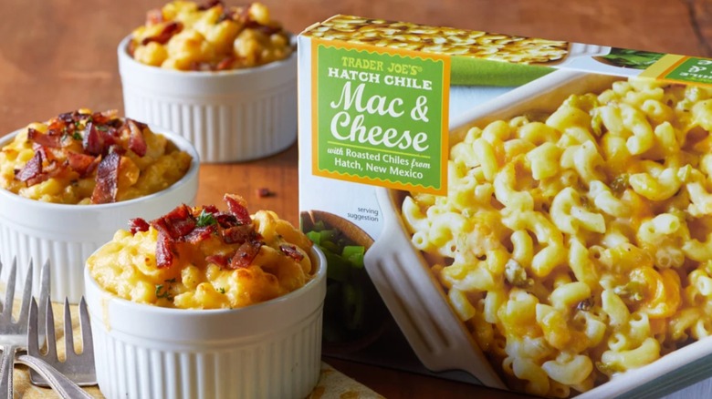 Trader Joe's Hatch Chile Mac & Cheese served in ramekins topped with bacon next to the product packaging