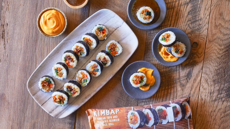 Trader Joe's Kimbap presented on a serving tray and on individual plates on a wood table