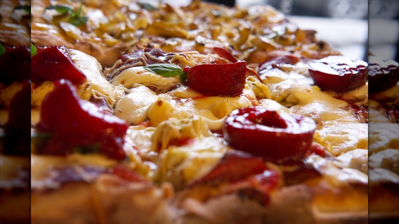 Close up on a pizza with sweet plums in Moscow cafe