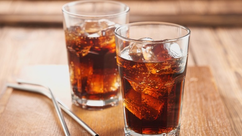 Two glasses of cola in glasses with ice