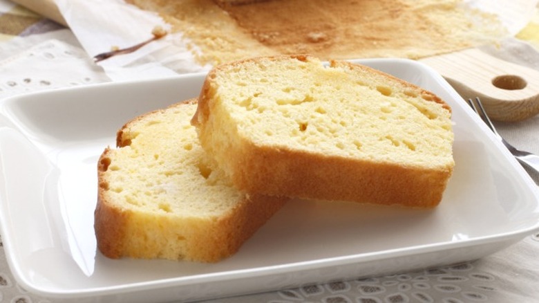 Two slices of pound cake on a square white plate.