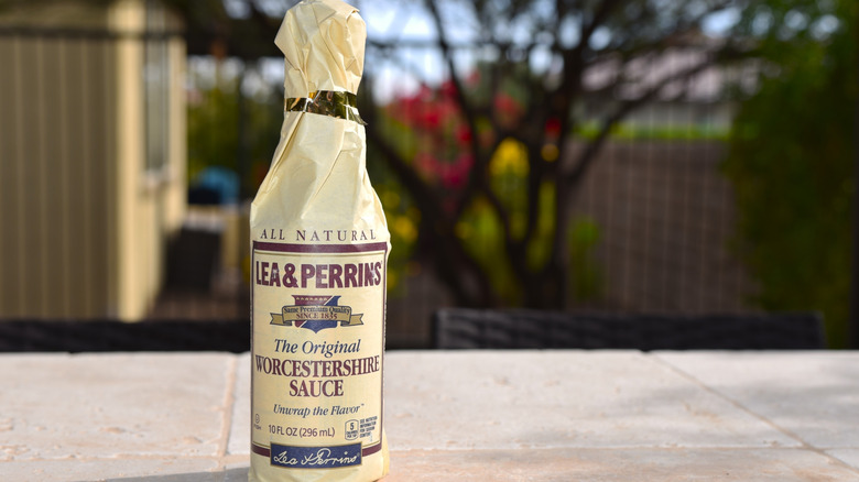 Bottles of Worcestershire sauce on a supermarket shelf.