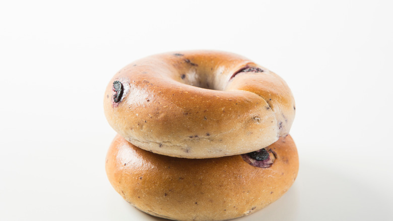 Close up of two blueberry bagels on white background