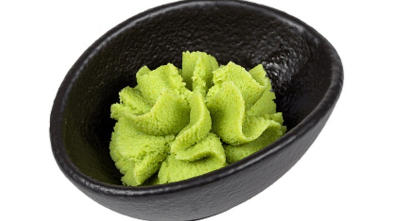 wasabi in black cup isolated on white background
