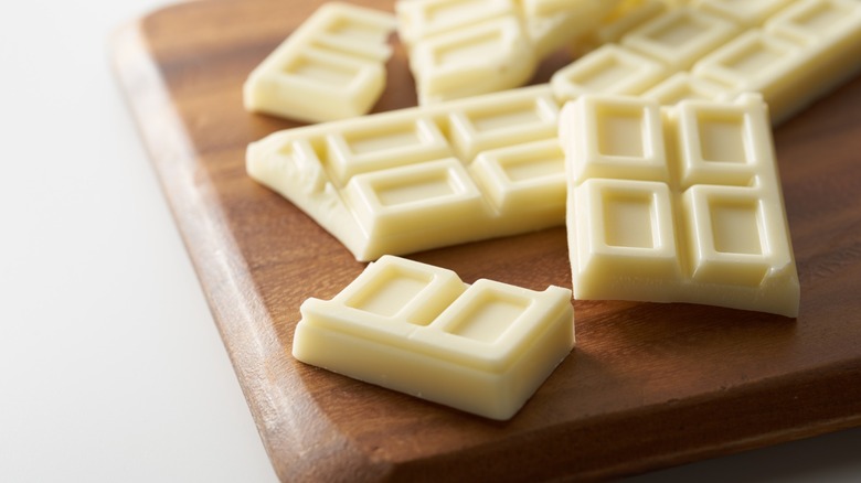 White chocolate blocks on a wooden cutting board