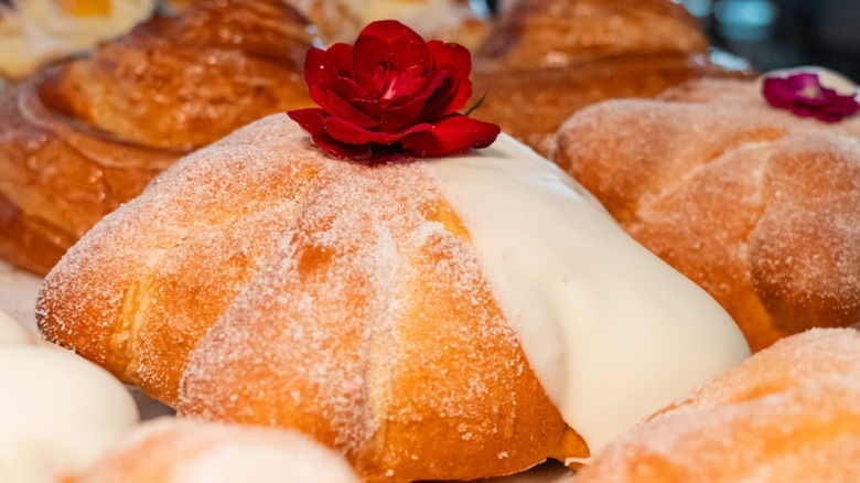 Pan de Muerto with fresh rose on top at La Concha Bakery & Coffee