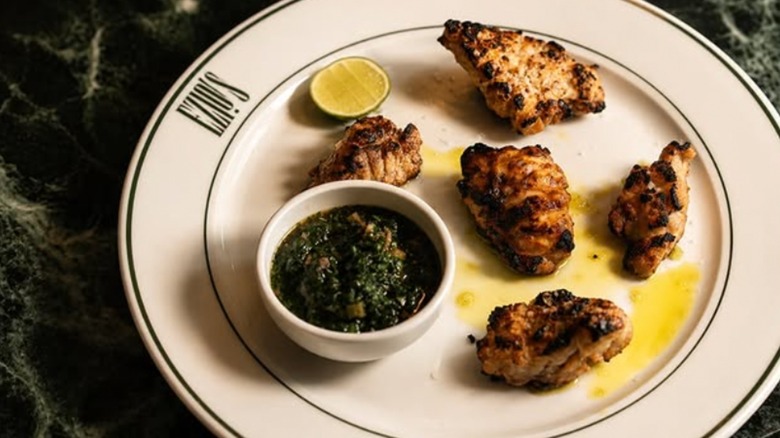 Order of Sweetbreads with a side of spinach on a white plate at Ezio's