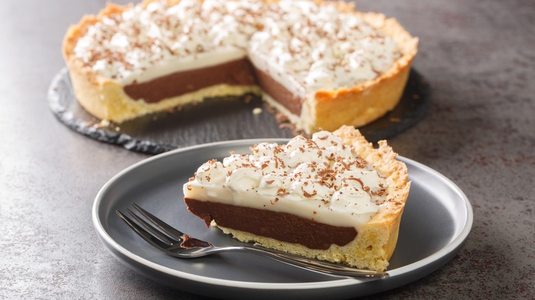Homemade slice of Hawaiian Chocolate Haupia Pie on a plate on the table