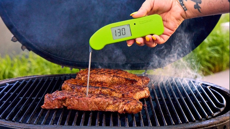 ThermoWorks Thermapen ONE meaasuring the temperature of steak on a grill