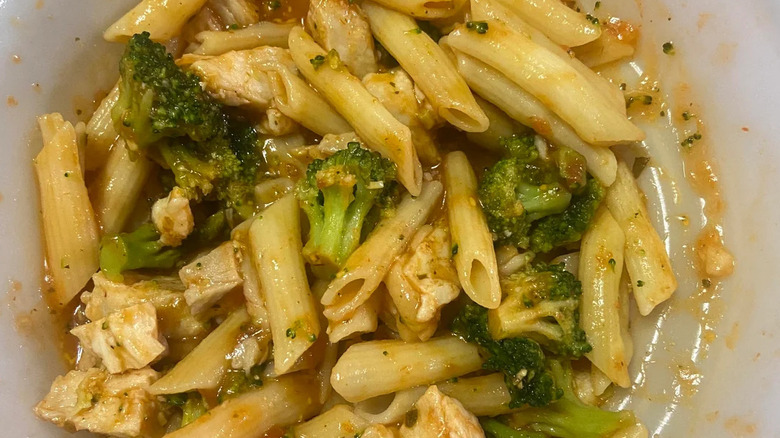 A closeup of a cooked bowl of Healthy Choice café steamers grilled chicken marinara with parmesan