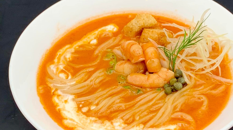 A close up of a bowl of seafood ramen
