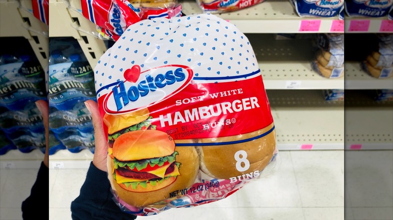 Hand holds package of Hostess Hamburger buns