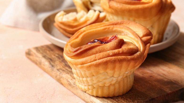 Freshly baked cruffins on a wooden board