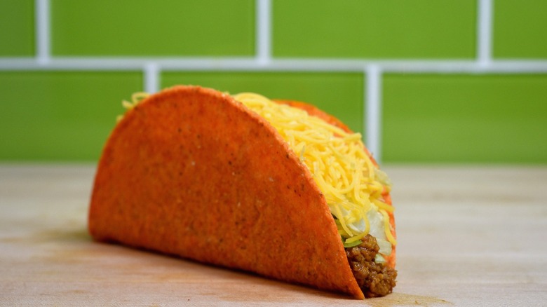 The Doritos Locos Taco in front of a green wall