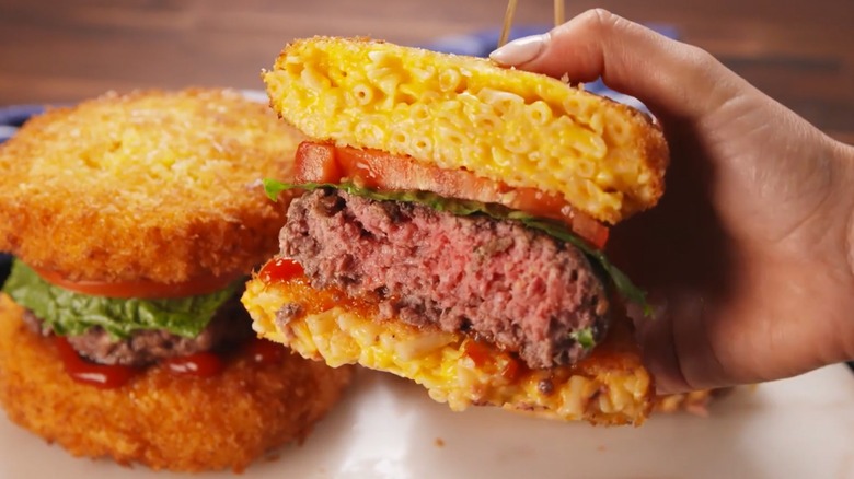 Hand holding a Mac-Bun Burger