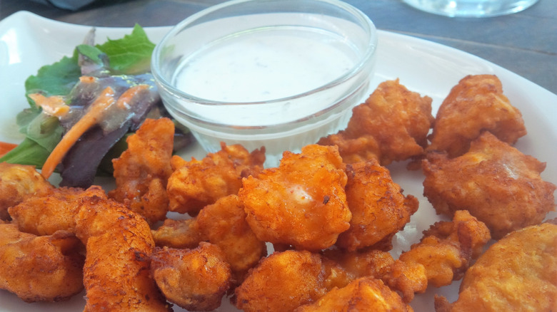 Plate of alligator nuggets with dipping sauce