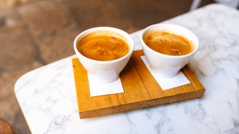Two Cuban coffees on a wooden block