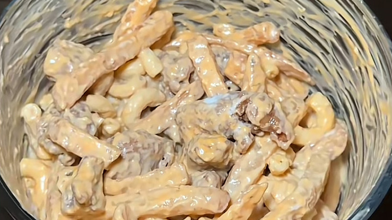 A top-down view of the loaded KFC fries hack inside a glass bowl.