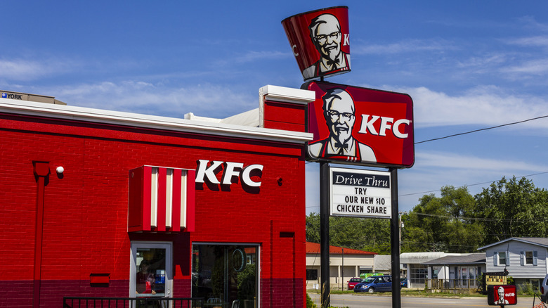 The outside of the KFC restaurant, with the iconic sign in red with white lettering.