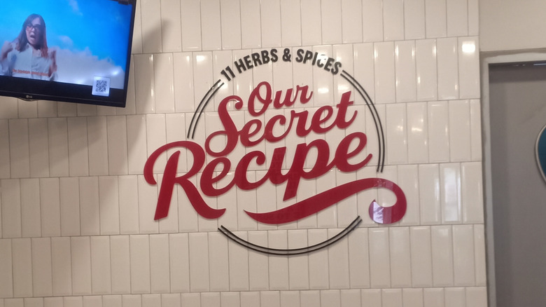 A photo of a red and black sign reading "11 herbs & Spices Our Secret Recipe".