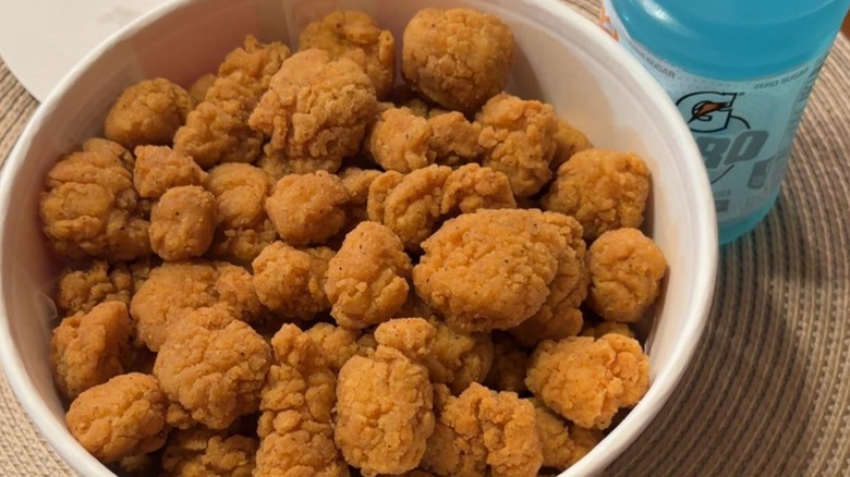 A top-down view of a bucket of popcorn chicken from KFC.
